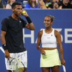 
              Canada's Felix Auger-Aliassime, and Leylah Fernandez, talk to John McEnroe during a "The Tennis Plays for Peace" exhibition match to raise awareness and humanitarian aid for Ukraine Wednesday, Aug. 24, 2022, in New York. The 2022 U.S. Open Main Draw will begin on Monday, Aug. 29, 2022. (AP Photo/Frank Franklin II)
            