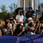 
              Tennis fans wait and hope for an autograph from Serena Williams before her first round match against Danka Kovinic, of Montenegro, at the US Open tennis championships, Monday, Aug. 29, 2022, in New York. (AP Photo/Julia Nikhinson)
            