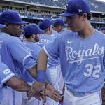 
              Kansas City Royals' Nick Pratto (32) celebrates with teammates after the first game of a baseball doubleheader against the Chicago White Sox Tuesday, Aug. 9, 2022, in Kansas City, Mo. The Royals won 4-2. (AP Photo/Charlie Riedel)
            