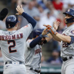 
              Houston Astros' Trey Mancini (26) celebrates with Jose Altuve and Alex Bregman (2) after hitting a grand slam off Cleveland Guardians starting pitcher Hunter Gaddis during the third inning of a baseball game Friday, Aug. 5, 2022, in Cleveland. (AP Photo/Ron Schwane)
            