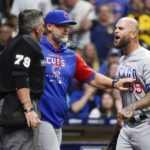 
              Chicago Cubs manager David Ross holds back first base coach Mike Napoli as he argues with umpire Manny Gonzalez during the seventh inning of a baseball game Saturday, Aug. 27, 2022, in Milwaukee. Napoli was ejected from the game. (AP Photo/Morry Gash)
            