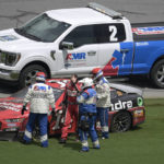
              Chase Briscoe (14) is helped away from his car after wrecking along the front stretch after coming out of Turn 4 during a NASCAR Cup Series auto race at Daytona International Speedway, Sunday, Aug. 28, 2022, in Daytona Beach, Fla. (AP Photo/Phelan M. Ebenhack)
            