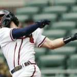 
              Atlanta Braves shortstop Dansby Swanson (7) hits a single in the sixth inning of a baseball game against the Philadelphia Phillies, Wednesday, Aug. 3, 2022, in Atlanta. (AP Photo/John Bazemore)
            