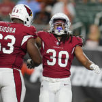 
              Arizona Cardinals running back Keaontay Ingram (30) celebrates with Danny Isidora (63) after scoring a touchdown during the second half of the team's NFL football preseason game against the Cincinnati Bengals in Cincinnati, Friday, Aug. 12, 2022. (AP Photo/Michael Conroy)
            