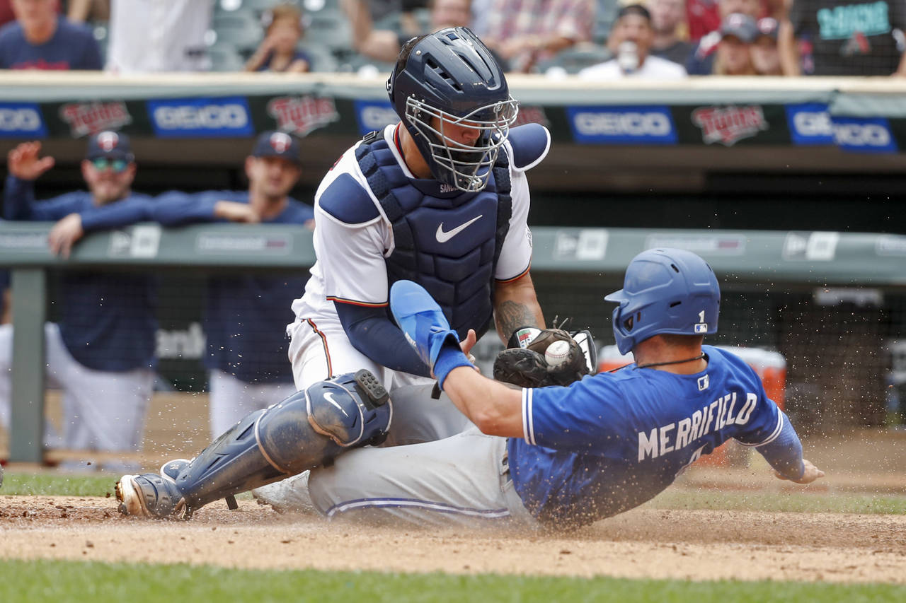 Minnesota Twins catcher Gary Sanchez tags out Toronto Blue Jays' Whit Merrifield who tags from thir...