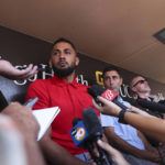 
              San Diego Padres' Fernando Tatis Jr., center, speaks to the media about his 80 game suspension from baseball after testing positive for Clostebol, a performance-enhancing substance in violation of Major League Baseball's Joint Drug Prevention and Treatment Program, Tuesday, Aug. 23, 2022, in San Diego. (AP Photo/Derrick Tuskan)
            
