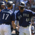 
              Seattle Mariners' Mitch Haniger, center, is congratulated by Jesse Winker, left, and Julio Rodriguez after hitting a three-run home run off Cleveland Guardians starting pitcher Triston McKenzie during the first inning of a baseball game, Thursday, Aug. 25, 2022, in Seattle. (AP Photo/Stephen Brashear)
            
