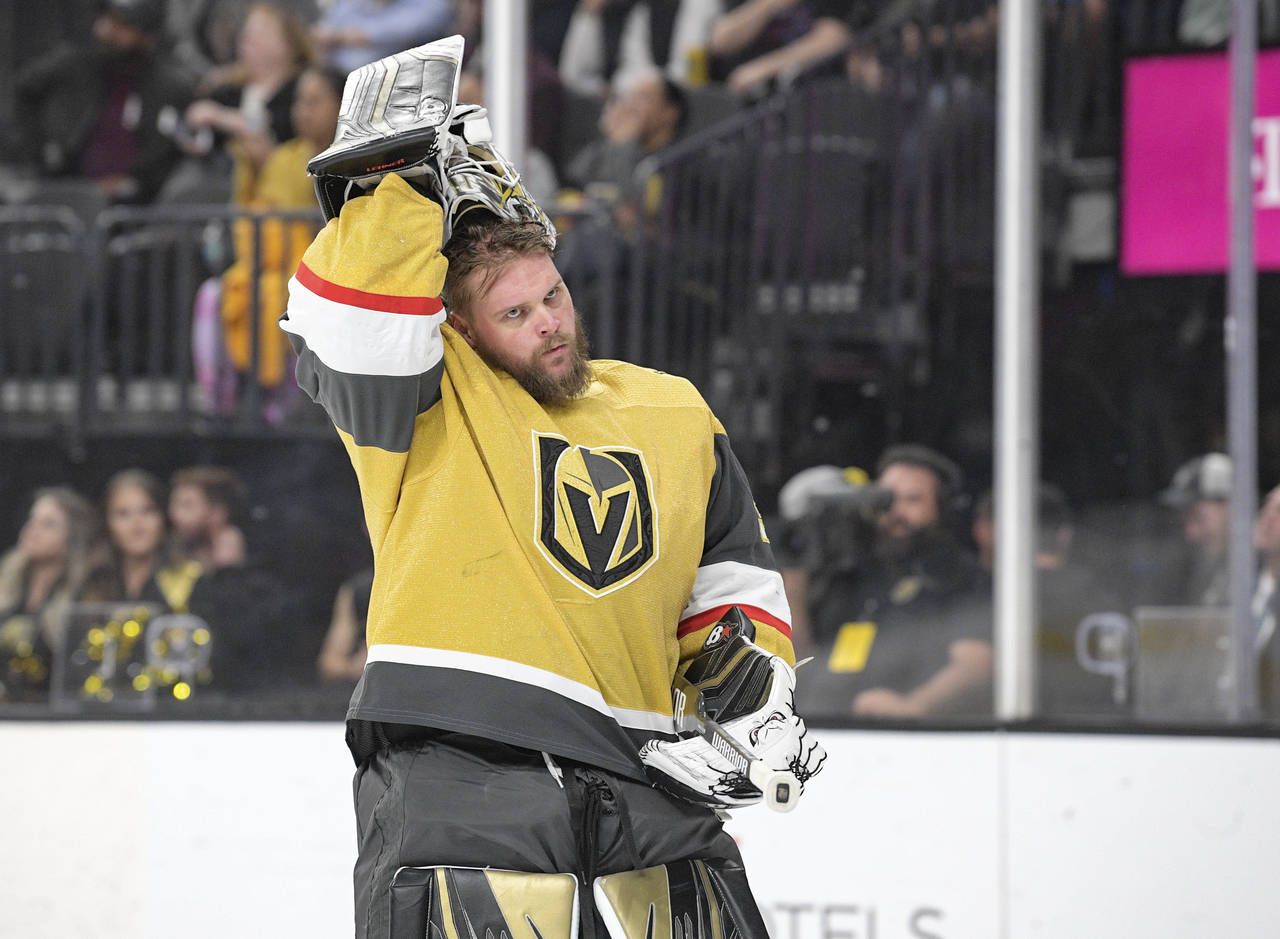 FILE - Vegas Golden Knights goaltender Robin Lehner puts his helmet on before the team's NHL game a...