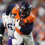 
              Denver Broncos linebacker Baron Browning (56) runs a fumble in for a touchdown against the Minnesota Vikings during the first half of an NFL preseason football game, Saturday, Aug. 27, 2022, in Denver. (AP Photo/David Zalubowski)
            