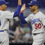 
              L.A. Dodgers manager Dave Roberts (30) congratulates right fielder Mookie Betts (50) at the end of a baseball game against the Miami Marlins, Sunday, Aug. 28, 2022, in Miami. The Dodgers defeated the Marlins 8-1. (AP Photo/Marta Lavandier)
            
