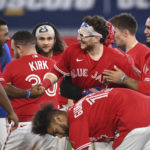
              Toronto Blue Jays' Danny Jansen, center, celebrates with teammates after hitting a walkoff-single, scoring Matt Chapman, in the 11th inning to defeat the Chicago Cubs in baseball game action in Toronto, Monday, Aug. 29, 2022. (Jon Blacker/The Canadian Press via AP)
            