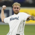 
              Boxer Jake Paul throws the ceremonial first pitch before a baseball game between the Miami Marlins and the San Diego Padres, Tuesday, Aug. 16, 2022, in Miami. (AP Photo/Marta Lavandier)
            