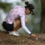 
              New Zealand's Lydia Ko moves wood chips on the ground as she prepares to hit the ball during the first round of the CP Women's Open golf tournament, Thursday, Aug. 25, 2022, in Ottawa, Ontario. (Justin Tang/The Canadian Press via AP)
            