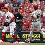 
              Cincinnati Reds first baseman Joey Votto, left, gets an out at first on Philadelphia Phillies Bryson Stott during the first inning of a baseball game in Cincinnati on Tuesday, Aug. 16, 2022. (AP Photo/Paul Vernon)
            
