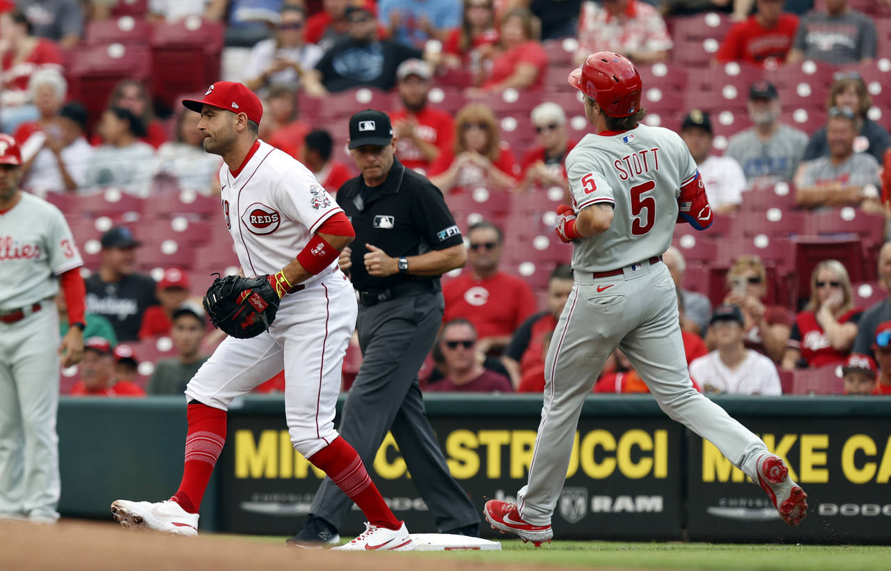 Cincinnati Reds first baseman Joey Votto, left, gets an out at first on Philadelphia Phillies Bryso...