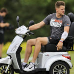 
              Cincinnati Bengals' Joe Burrow sits on a scooter as he watches during the NFL football team's training camp in Cincinnati, Monday, Aug. 1, 2022. (AP Photo/Aaron Doster)
            