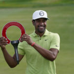 
              Tony Finau holds the winner's trophy after the final round of the Rocket Mortgage Classic golf tournament, Sunday, July 31, 2022, in Detroit. (AP Photo/Carlos Osorio)
            
