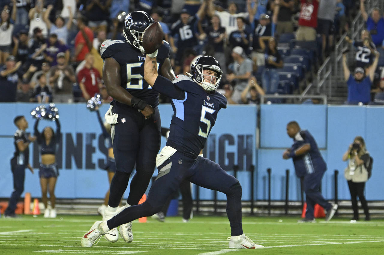 Tennessee Titans quarterback Logan Woodside (5) spikes the ball after scoring a touchdown on a 9-ya...