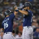 
              Seattle Mariners' Abraham Toro, right, celebrates his two-run home run with Adam Frazier (26) in the seventh inning of a baseball game against the Detroit Tigers in Detroit, Wednesday, Aug. 31, 2022. (AP Photo/Paul Sancya)
            