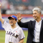 
              The Japanese consul-general in New York, Ambassador Mikio Mori, left, and former New York Mets pitcher Masato Yoshii waive to fans after a ceremonial first pitch before a baseball game between the Mets and the Colorado Rockies, Thursday, Aug. 25, 2022, in New York. (AP Photo/Frank Franklin II)
            