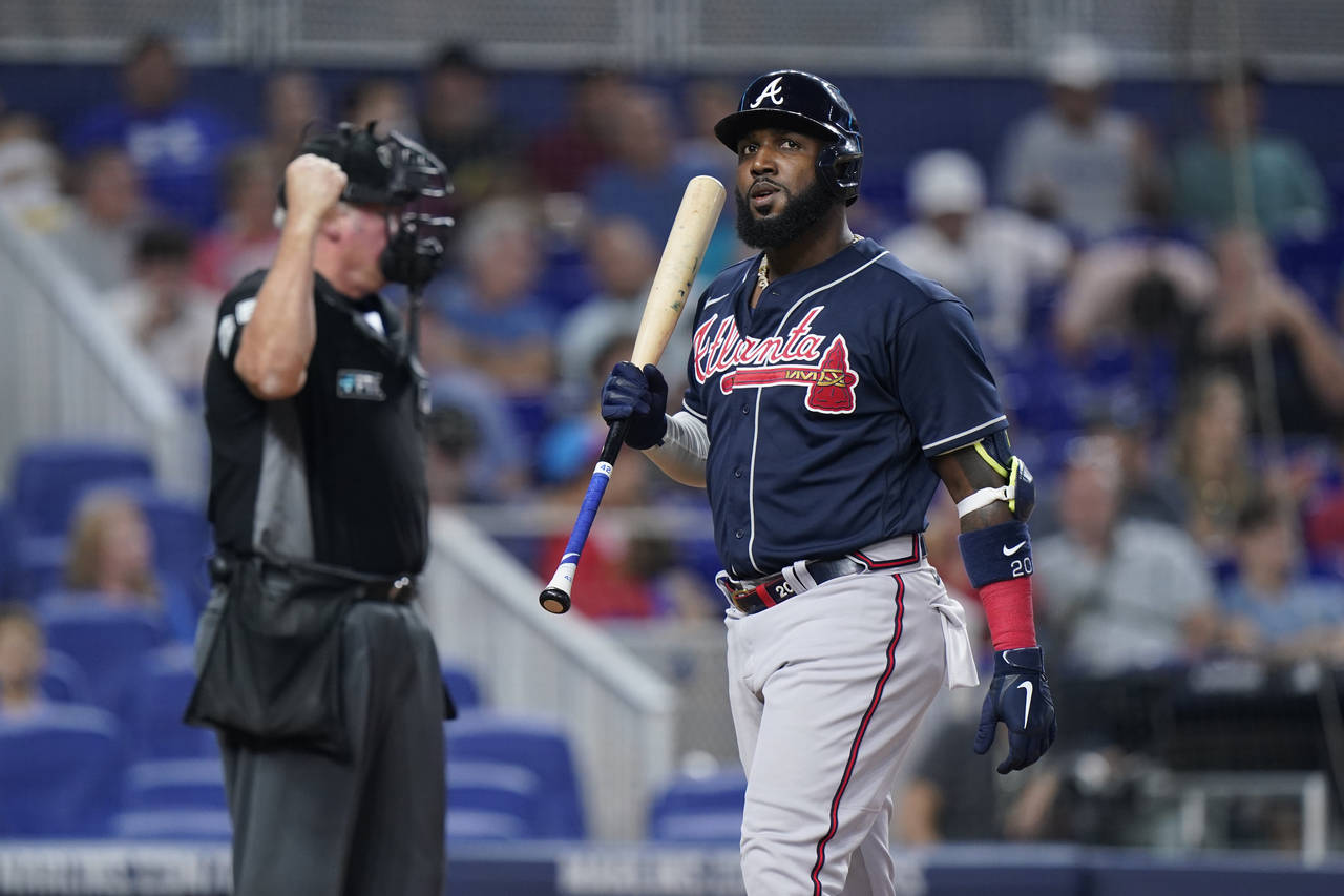 Atlanta Braves' Marcell Ozuna reacts after striking out during the seventh inning of a baseball gam...