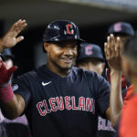 
              Cleveland Guardians' Oscar Gonzalez celebrates after scoring against the Detroit Tigers in the eighth inning of a baseball game in Detroit, Tuesday, Aug. 9, 2022. (AP Photo/Paul Sancya)
            