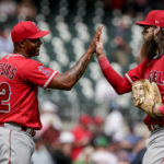 
              Los Angeles Angels relief pitcher Raisel Iglesias (32) celebrates with teammate Brandon Marsh, right, after defeating the Atlanta Braves in a baseball game Sunday, July 24, 2022, in Atlanta. (AP Photo/Butch Dill)
            