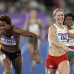 
              Team Canada's Kyra Constantine, left, and Team England's Jessie Knight cross the finish line of the Women's 4 x 400 meters relay during the athletics competition in the Alexander Stadium at the Commonwealth Games in Birmingham, England, Sunday, Aug. 7, 2022. England crossed ahead but was later disqualified and Canada took the gold medal. (AP Photo/Manish Swarup)
            