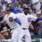 
              Chicago Cubs' Willson Contreras, left, and third base coach Willie Harris react after Contreras hit a two-run home run during the fifth inning of a baseball game against the Milwaukee Brewers in Chicago, Saturday, Aug. 20, 2022. (AP Photo/Nam Y. Huh)
            