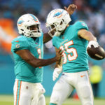 
              Miami Dolphins quarterback Tua Tagovailoa (1) and wide receiver River Cracraft (85) celebrate after Cracraft caught a pass in the end zone for a touchdown during the first half of a NFL preseason football game against the Philadelphia Eagles, Saturday, Aug. 27, 2022, in Miami Gardens, Fla. (AP Photo/Wilfredo Lee)
            