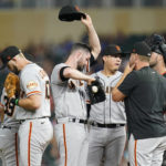 
              San Francisco Giants starting pitcher Alex Wood, middle, reacts as pitching coach Andrew Bailey, second right, comes to the mound during the third inning of a baseball game against the Minnesota Twins Friday, Aug. 26, 2022, in Minneapolis. (AP Photo/Abbie Parr)
            
