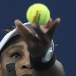 
              Serena Williams, of the United States, tosses the ball for a serve to Belinda Bencic, of Switzerland, during the National Bank Open tennis tournament Wednesday, Aug. 10, 2022, in Toronto. (Nathan Denette/The Canadian Press via AP)
            