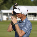 
              Will Zalatoris kisses the trophy after winning the St. Jude Championship golf tournament, Sunday, Aug. 14, 2022, in Memphis, Tenn. (AP Photo/Mark Humphrey)
            