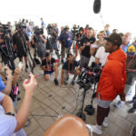 
              Cleveland Browns quarterback Deshaun Watson speaks to the media, Thursday, Aug. 18, 2022, in Berea, Ohio, after the team announced that Watson has reached a settlement with the NFL and will serve an 11-game unpaid suspension and pay a $5 million fine rather than risk missing his first season as quarterback of the Cleveland Browns following accusations of sexual misconduct while he played for the Houston Texans. (Joshua Gunter/Cleveland.com via AP)
            