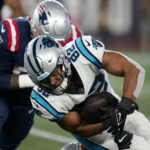 
              Carolina Panthers tight end Tommy Tremble (82) is tackled by New England Patriots defensive tackle Daniel Ekuale during the first half of a preseason NFL football game Friday, Aug. 19, 2022, in Foxborough, Mass. (AP Photo/Charles Krupa)
            