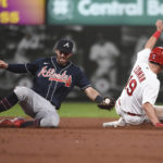 
              St. Louis Cardinals' Tommy Edman (19) safely steals second base ahead of a tag from Atlanta Braves shortstop Dansby Swanson (7) in the third inning of a baseball game against on Friday, Aug. 26, 2022, in St. Louis. (AP Photo/Joe Puetz)
            