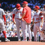 
              Los Angeles Angels starting pitcher Jaime Barria, second from left, is pulled from the mound during the fourth inning of a baseball game against the Seattle Mariners, Saturday, Aug. 6, 2022, in Seattle. (AP Photo/Caean Couto)
            