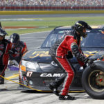 
              FILE - Kimi Raikkonen, of Finland, makes a pit stop during the NASCAR Nationwide Series auto race May 28, 2011, in Concord, N.C. Raikkonen will take a break from his retirement to return to racing this weekend in the NASCAR race at Watkins Glen. (AP Photo/Terry Renna, File)
            