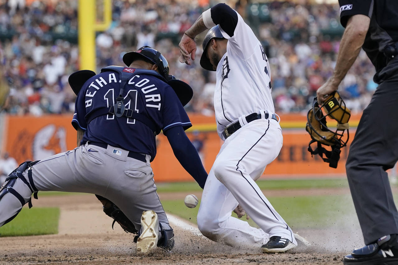 Tampa Bay Rays catcher Christian Bethancourt bobbles the throw from left fielder David Peralta as D...