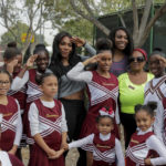 
              FILE - Serena Williams, center left, and sister, Venus, pose with the members of the Compton Sounders drill team after attending a dedication ceremony of the Lueders Park tennis courts Saturday, Nov. 12, 2016, in Compton, Calif. The courts were dedicated in their name. After nearly three decades in the public eye, few can match Serena Williams' array of accomplishments, medals and awards. Through it all, the 23-time Grand Slam title winner hasn't let the public forget that she's a Black American woman who embraces her responsibility as a beacon for her people. (AP Photo/Jae C. Hong, File)
            