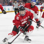 
              Canada's Connor Bedard (16) skates with the puck as Czechia's Matyas Spovaliv (24) defends during the second period of an IIHF world junior hockey championships game in Edmonton, Alberta, Saturday, Aug. 13, 2022. (Jason Franson/The Canadian Press via AP)
            