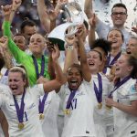 
              FILE - England's Nikita Parris lifts the trophy after winning the Women's Euro 2022 final soccer match between England and Germany at Wembley stadium in London, Sunday, July 31, 2022. England won 2-1. (AP Photo/Alessandra Tarantino, File)
            