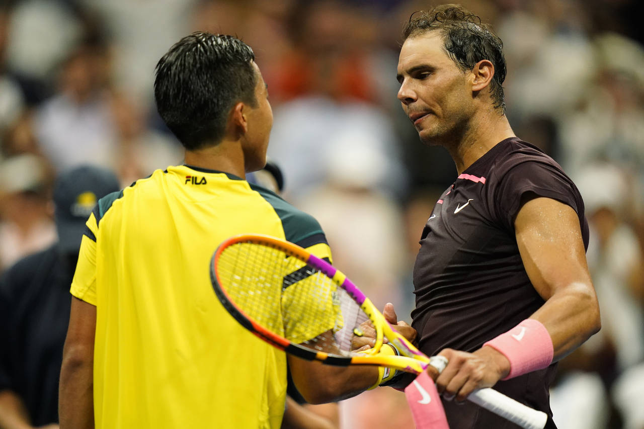Rafael Nadal, right, of Spain, shakes hands with Rinky Hijikata, of Australia, during the first rou...