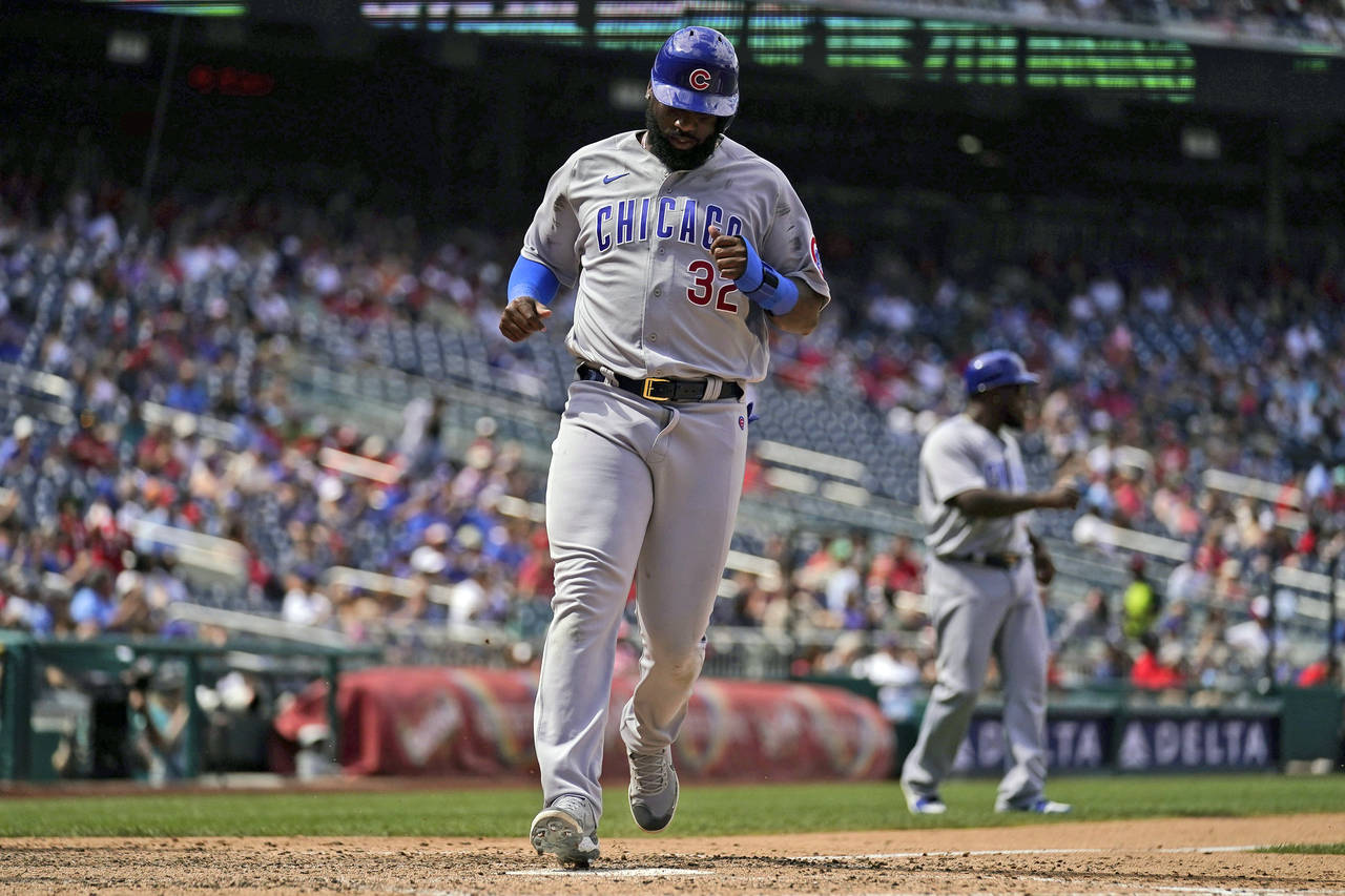 Chicago Cubs' Franmil Reyes scores the go ahead run on a single by Yan Gomes during the seventh inn...