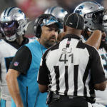 
              Carolina Panthers coach Matt Rhule, center, speaks with side judge Boris Cheek (41) during the first half of the team's preseason NFL football game against the New England Patriots, Friday, Aug. 19, 2022, in Foxborough, Mass. (AP Photo/Charles Krupa)
            