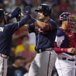 
              Atlanta Braves' Austin Riley, center, is congratulated by Dansby Swanson (7) after his two run home run off Boston Red Sox starting pitcher Rich Hill during the third inning of a baseball game, Tuesday, Aug. 9, 2022, in Boston. At right is Boston Red Sox catcher Kevin Plawecki. (AP Photo/Charles Krupa)
            