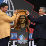 
              Former NFL player Tony Boselli, left, and his presenter Mar Brunell unveil his bust before speaking during his induction into the Pro Football Hall of Fame, Saturday, Aug. 6, 2022, in Canton, Ohio. (AP Photo/David Richard)
            