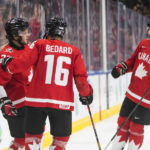 
              Canada's Mason McTavish (23), Connor Bedard (16) and Brennan Othmann (15) celebrate a goal against Czechia during the second period of an IIHF world junior hockey championships game in Edmonton, Alberta, Saturday, Aug. 13, 2022. (Jason Franson/The Canadian Press via AP)
            