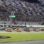
              A J Allmendinger (16) leads drivers through the front stretch at the start of a NASCAR Xfinity Series auto race at Daytona International Speedway, Friday, Aug. 26, 2022, in Daytona Beach, Fla. (AP Photo/Terry Renna)
            