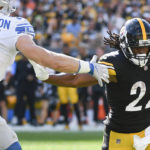 
              Pittsburgh Steelers running back Najee Harris (22) runs the ball as Detroit Lions defensive end Aidan Hutchinson (97) pursues him during the first half of an NFL preseason football game, Sunday, Aug. 28, 2022, in Pittsburgh. (AP Photo/Don Wright)
            